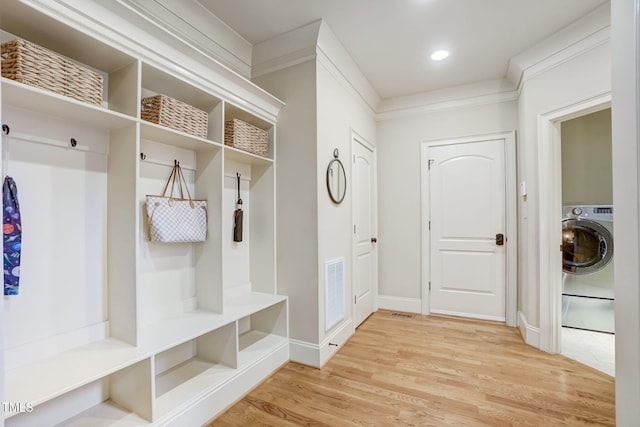 mudroom featuring ornamental molding, washer / dryer, and hardwood / wood-style floors