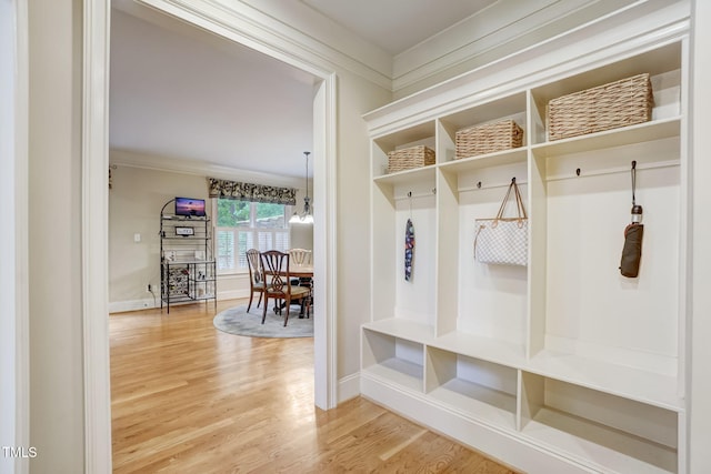 mudroom featuring hardwood / wood-style flooring and ornamental molding