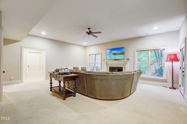 living room featuring ceiling fan and light colored carpet