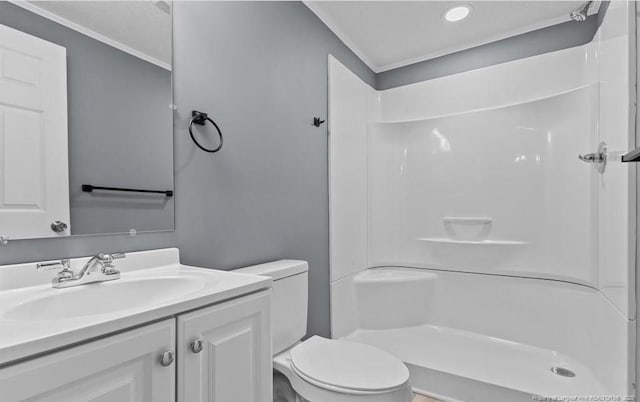 bathroom with vanity, toilet, and a shower