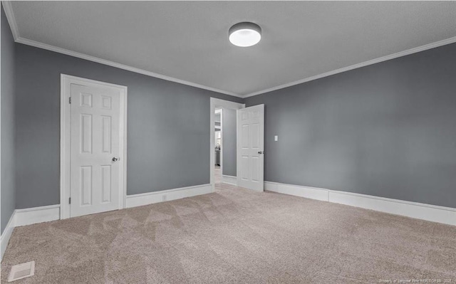 carpeted empty room featuring ornamental molding