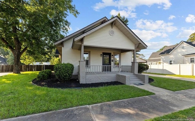 bungalow-style home featuring a porch and a front yard