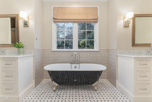 bathroom with tile patterned floors, vanity, tile walls, and a washtub