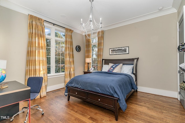 bedroom featuring wood-type flooring, crown molding, and a notable chandelier