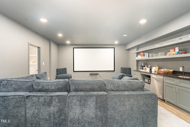 cinema room featuring light hardwood / wood-style floors and sink