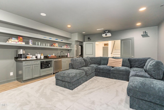 living room featuring light wood-type flooring and sink