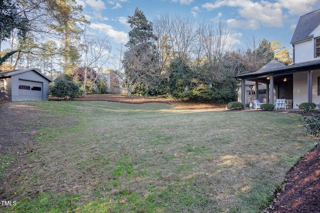 view of yard featuring an outdoor structure and a garage