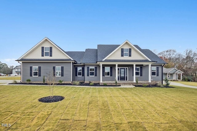 craftsman house with a front yard and covered porch