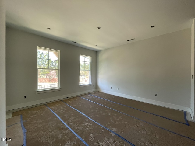 spare room with visible vents and baseboards