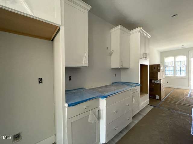 kitchen with white cabinetry and baseboards