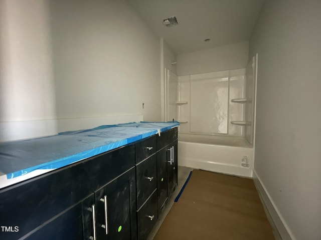 full bath featuring washtub / shower combination, baseboards, and vanity