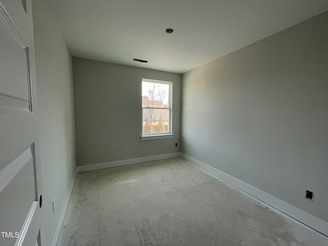 empty room with visible vents and baseboards