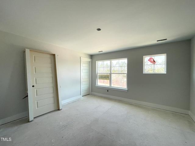 unfurnished bedroom with multiple windows and baseboards