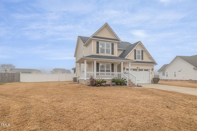 craftsman-style house with cooling unit, a porch, and a garage