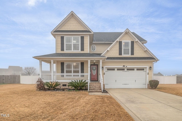 craftsman house with covered porch, a garage, and a front lawn