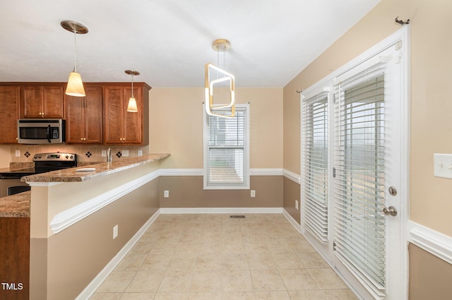 kitchen with kitchen peninsula, light stone counters, stainless steel appliances, light tile patterned floors, and decorative light fixtures