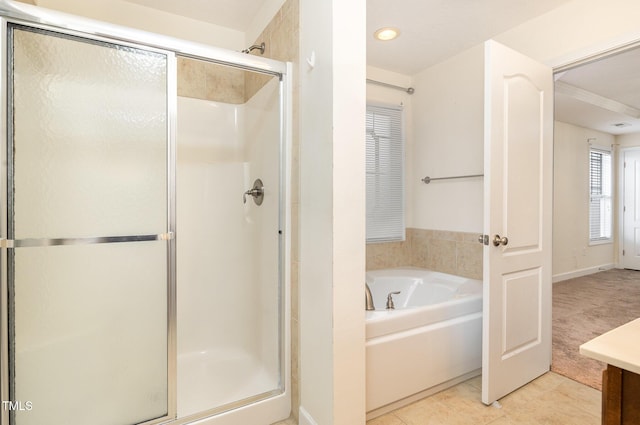 bathroom featuring tile patterned floors and independent shower and bath