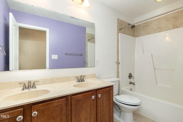 full bathroom featuring tiled shower / bath combo, tile patterned flooring, a textured ceiling, toilet, and vanity