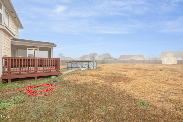 view of yard with a swimming pool side deck