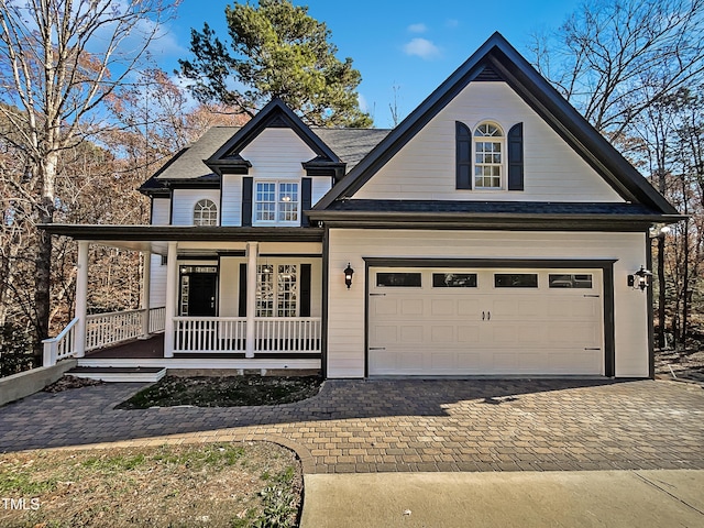 view of front of home featuring covered porch and a garage