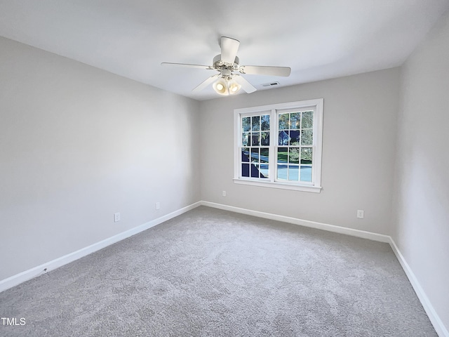 carpeted empty room featuring ceiling fan