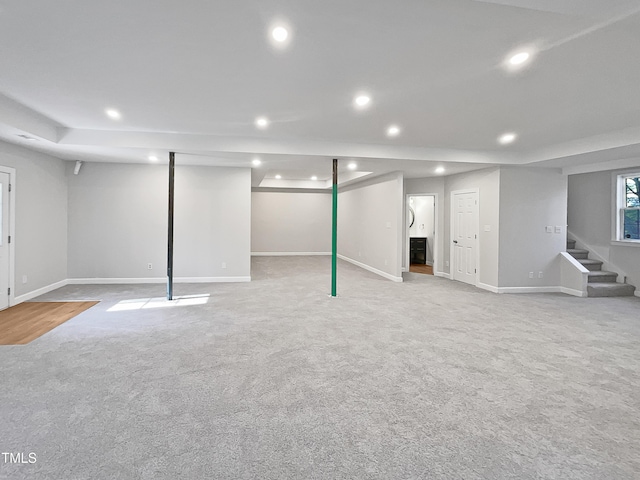 basement featuring light colored carpet