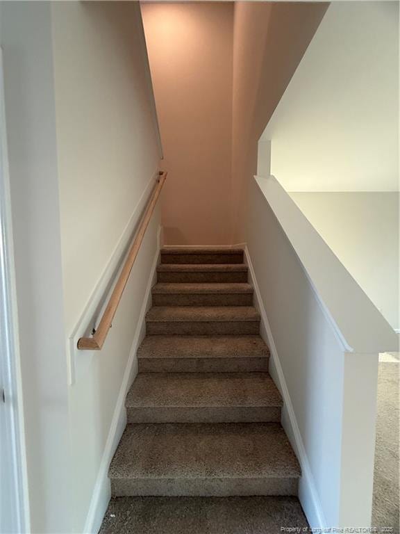 stairs featuring baseboards and speckled floor