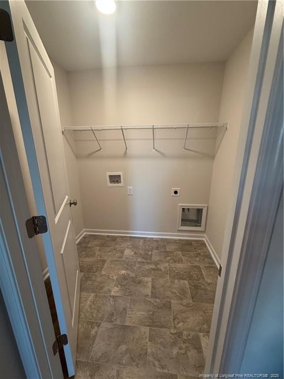 laundry room featuring hookup for a washing machine, laundry area, baseboards, stone finish floor, and electric dryer hookup