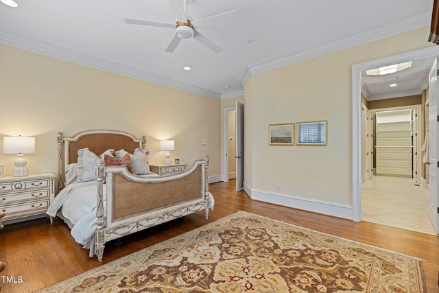 bedroom with crown molding, wood-type flooring, and ceiling fan