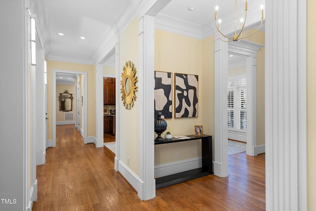 101 Bonica Creek Dr, Garner, NC 27529 - hallway featuring crown molding, wood finished floors, an inviting chandelier, and baseboards