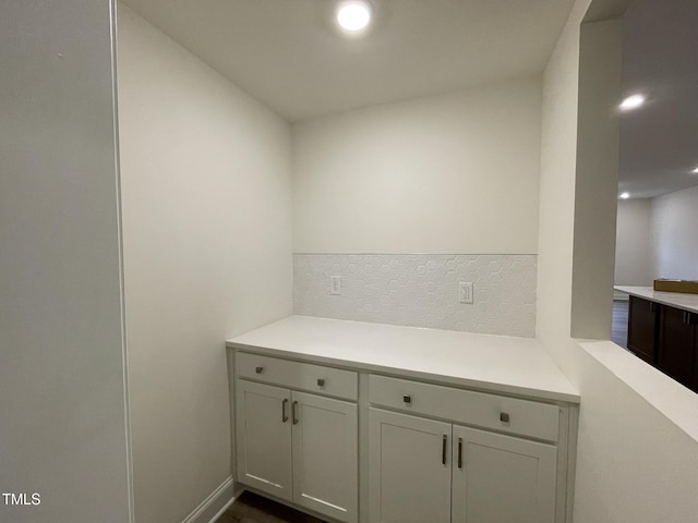 interior space with light countertops and tasteful backsplash