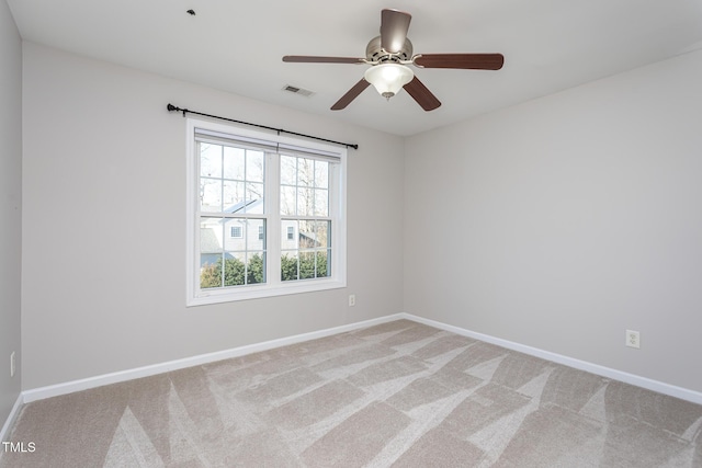 carpeted spare room with ceiling fan