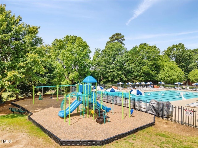 view of playground with a community pool