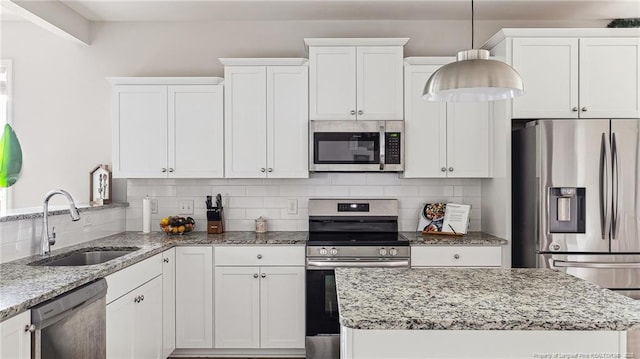 kitchen featuring decorative backsplash, sink, white cabinetry, and stainless steel appliances