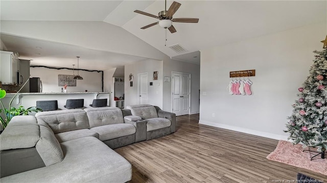 living room featuring ceiling fan, lofted ceiling, and hardwood / wood-style floors