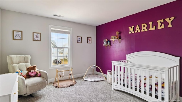 bedroom featuring carpet floors and a crib