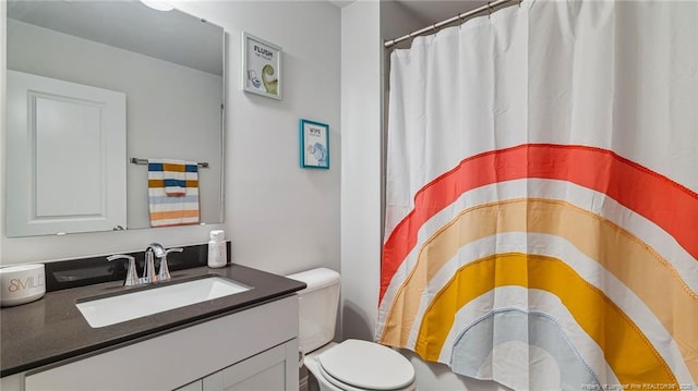 bathroom with toilet and vanity