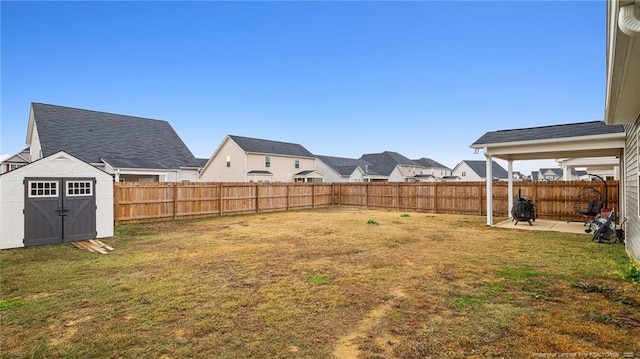 view of yard with a storage unit and a patio area