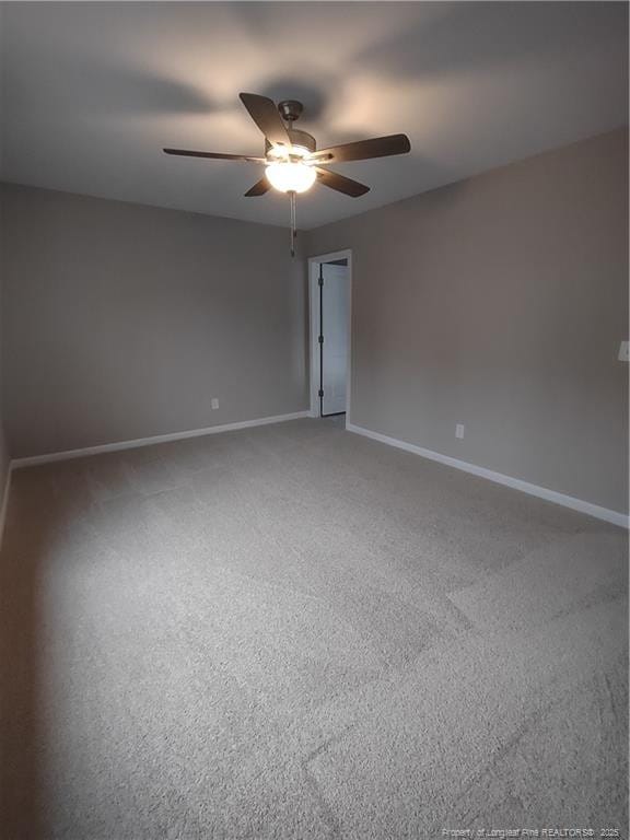 spare room featuring carpet floors and ceiling fan