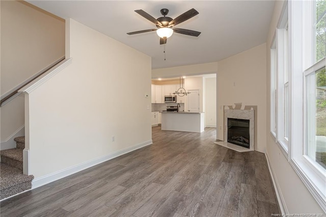501 Randolph Ave, Fayetteville, NC 28311 - unfurnished living room with stairway, dark wood-style flooring, a ceiling fan, and healthy amount of natural light