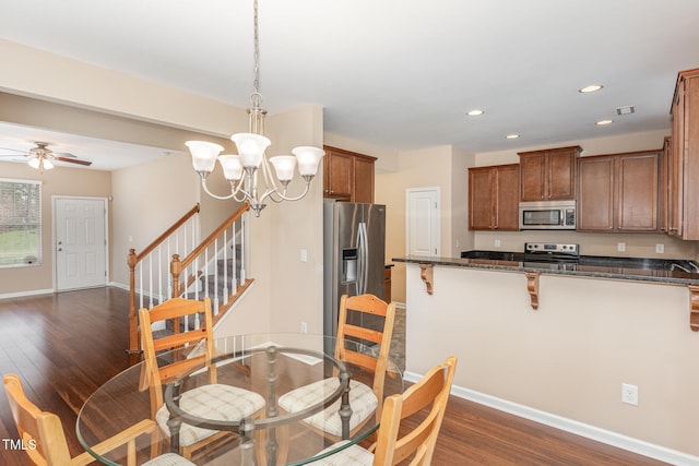 dining area with dark wood-type flooring, recessed lighting, stairway, and baseboards