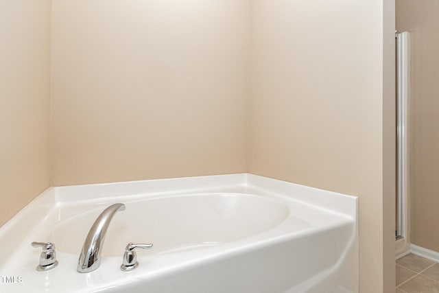 full bath featuring tile patterned flooring and a garden tub