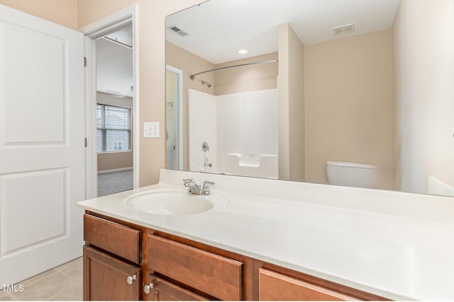 bathroom featuring visible vents, toilet, vanity, walk in shower, and tile patterned floors