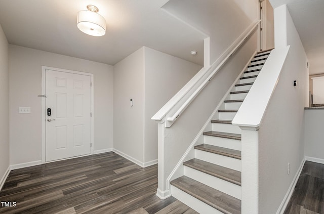 entrance foyer featuring stairway, baseboards, and wood finished floors