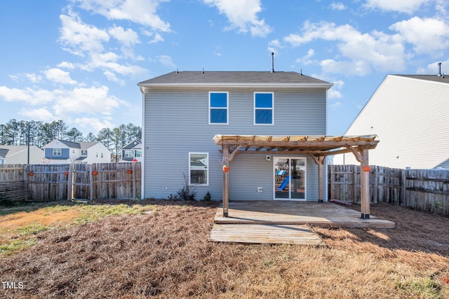 rear view of property featuring a fenced backyard, a lawn, and a pergola