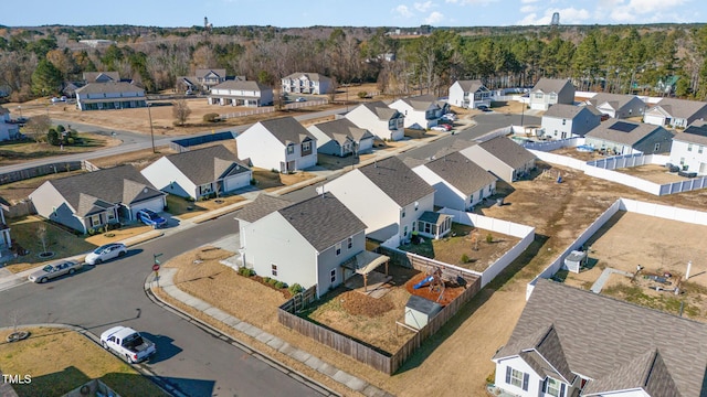 birds eye view of property featuring a residential view and a view of trees