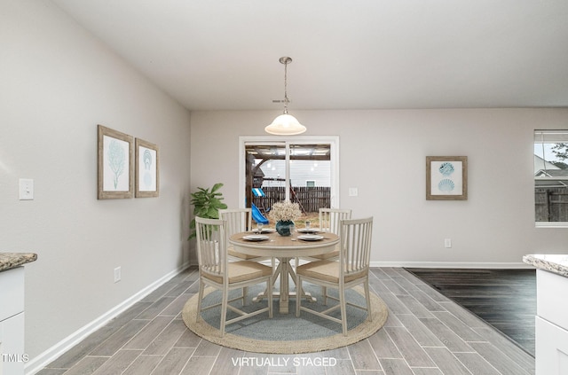 dining room with baseboards and wood tiled floor