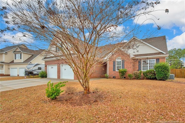 view of front of home with central AC unit and a garage