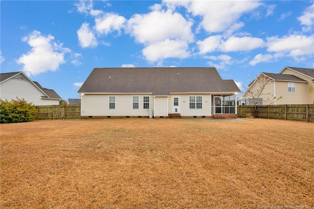 rear view of property featuring a lawn and a sunroom