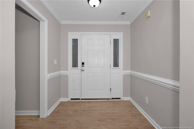 interior space featuring crown molding and light wood-type flooring